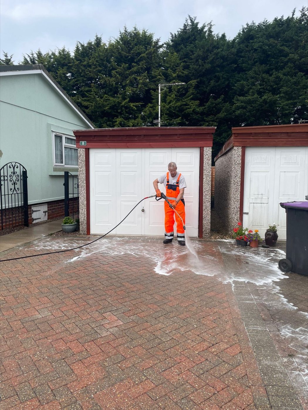 Applying cleaning foam to a block driveway