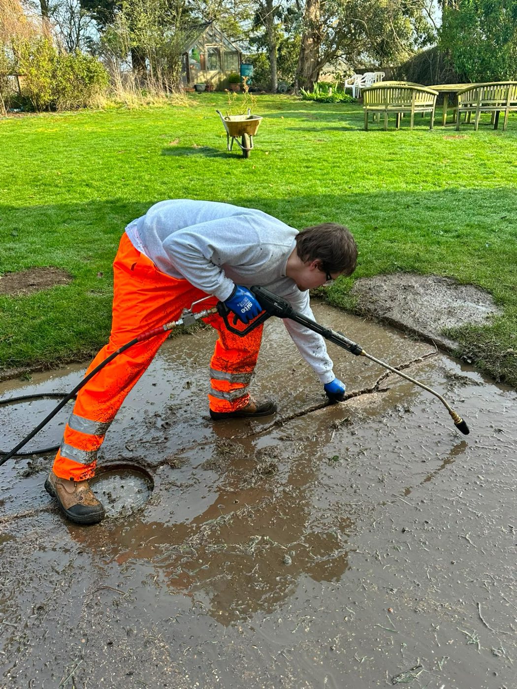 Cleaning a mud-covered paved area