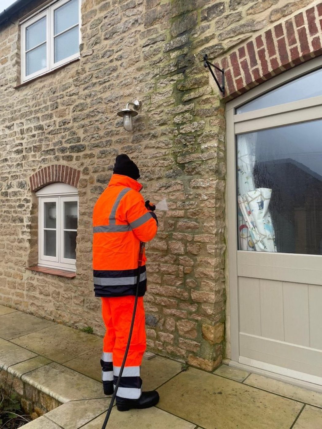 Pressure washing a garden wall